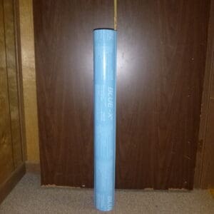 A blue tube of plastic in front of a door.